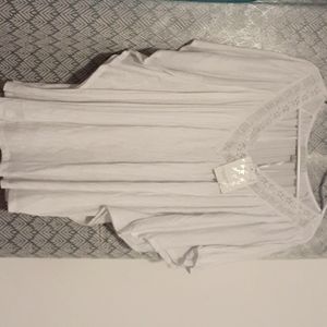 White blouse with circular sleeve.